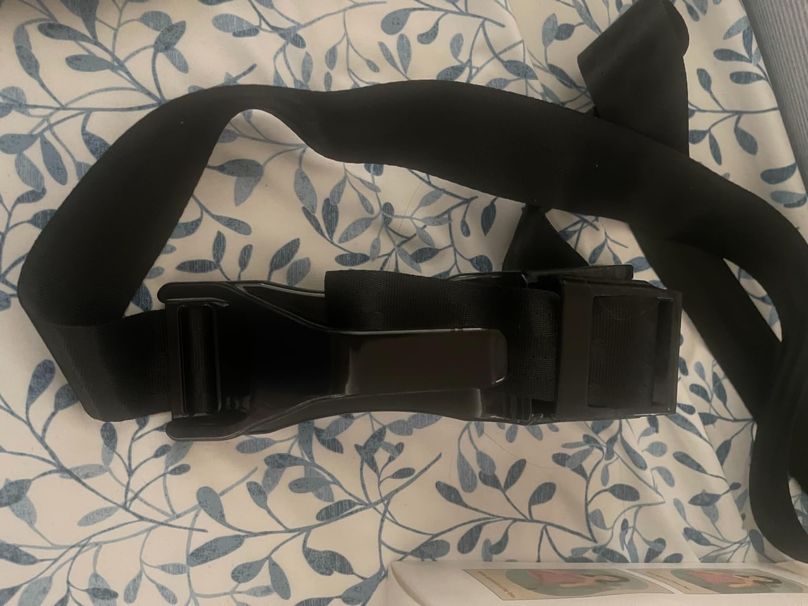 Pregnancy seat belt adjuster in use by an expectant mother in a car